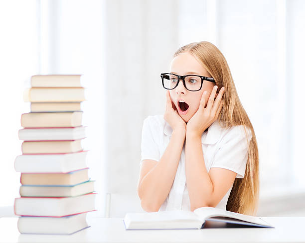 istock girl with many books at school 186182672