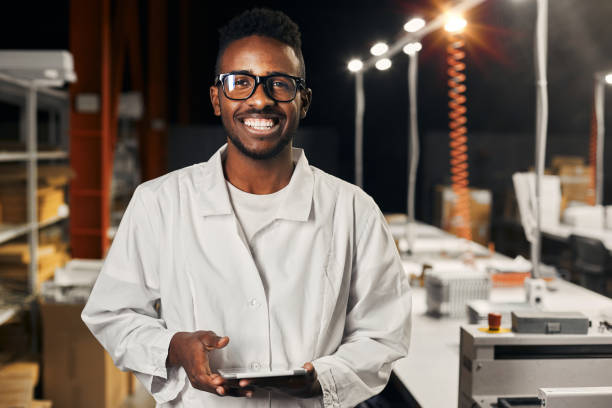 istock Smiling african engineer working with tablet at factory 1861833344