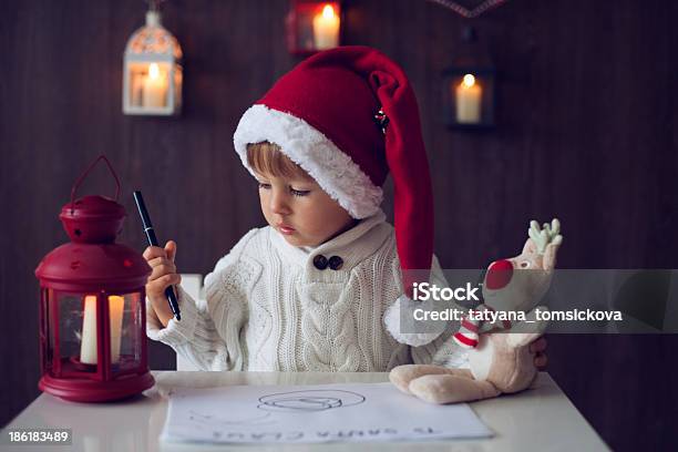 Boy Writing To Santa Stock Photo - Download Image Now - Anticipation, Atmospheric Mood, Beautiful People