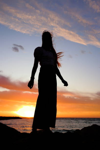 istock Young woman silhouette at sunset at sunset 1861835953