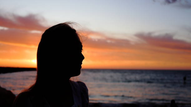 istock Young woman silhouette at sunset at sunset 1861837432