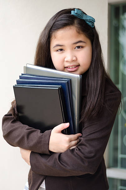 istock smiling business girl with folder, outdoor. 186185182
