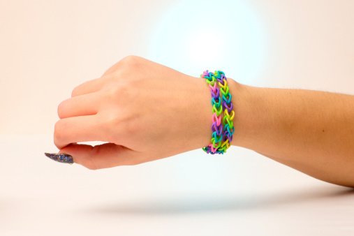 Close up of kids bracelet isolated on colored background.