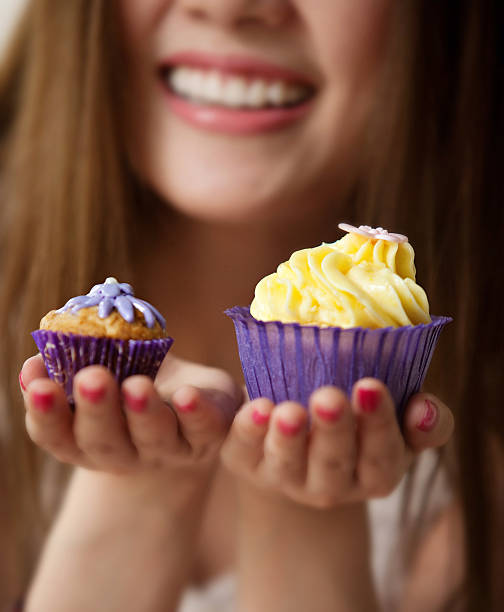 istock Woman holding a cup cake 186185524