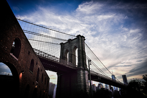 The Brooklyn Bridge is a hybrid cable-stayed/suspension bridge in New York City, spanning the East River between the boroughs of Manhattan and Brooklyn. St. Ann's Warehouse is a performing arts institution in Brooklyn, New York City.