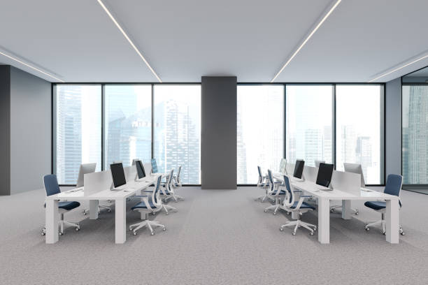 istock Cozy coworking interior with pc desktop in row, panoramic window 1861857757