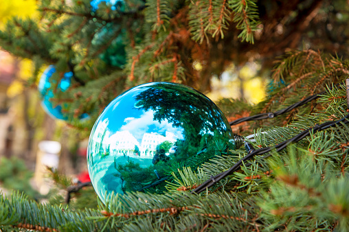 Christmas tree decoration with reflection of Bratislava building, photo taken in front of Slovak National Theater