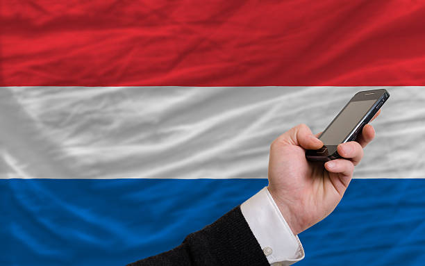 istock cell phone in front  national flag of holland 186186073