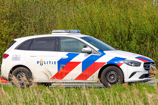 Blue flashlight at a police car of the regional police at incident in Waddinxveen