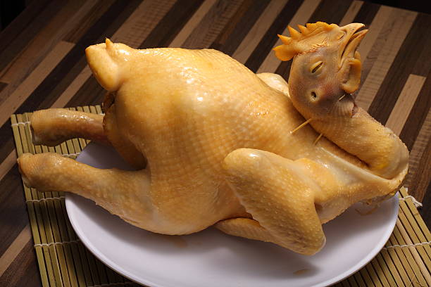 Traditional chinese cooked whole chicken isolated on white dish