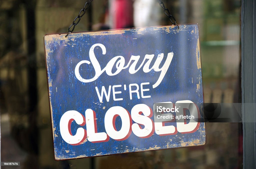 Old blue closed sign hanging in a shop window Vintage closed sign in shop window Closed Sign Stock Photo