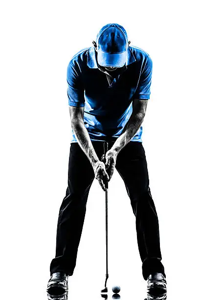 one man golfer golfing putting in silhouette studio on white background