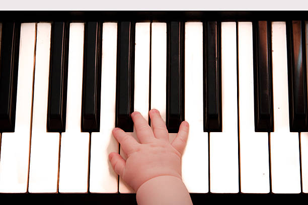istock the piano keyboard and little child hand 186188246