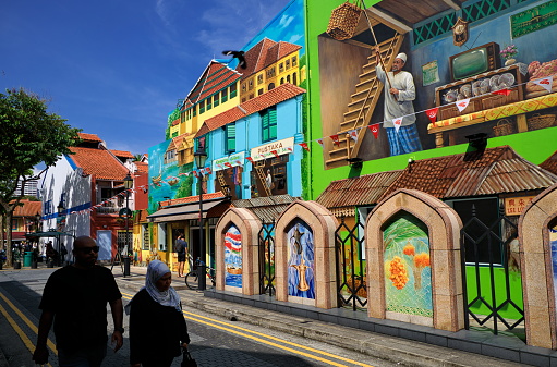 Kampong Gelam, Singapore - August 23, 2023 : Locals walking at the Malay district, called Kampong Gelam or Geylang Serai, an area where the wall art is like a public and outdoor art exhibition.
