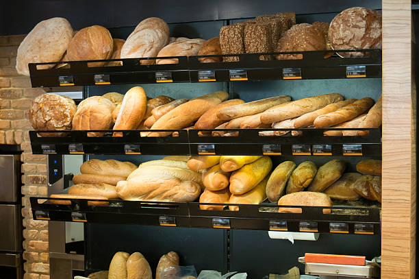 istock Different types of fresh bread and rolls on sale at a bakery 186190133