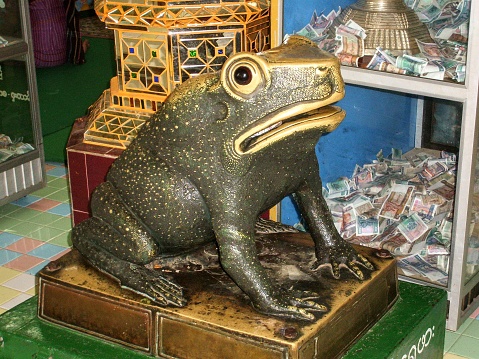 Sagaing Hill. The Sone Oo Pone Nya Shin Pagoda is a Buddhist Pagoda located high on top of Nya-pha Hill. That hill is a little like a frog and that explains this large frog-shaped donation box inside. And obviously it works well looking at all the collected money next to the frog.