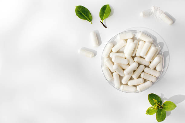 White capsules with minerals or food additives with an organic composition. Vitamins. Copy space