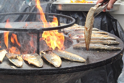 Raw fish roasting on a grill
