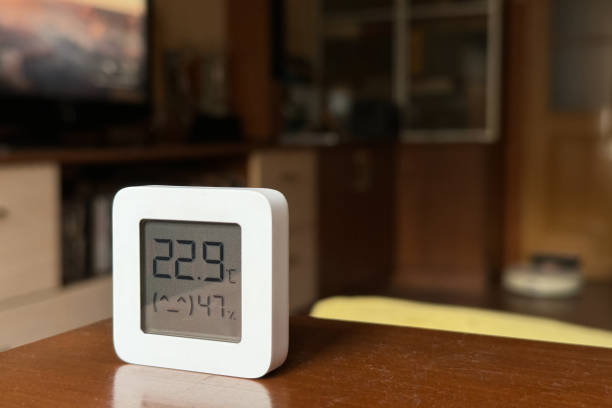 istock Comfortable humidity and temperature in the apartment. White hygrometer on the table 1861976700