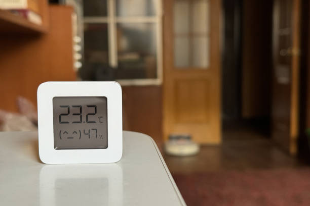 istock Comfortable humidity and temperature in the apartment. White hygrometer on the table 1861976942