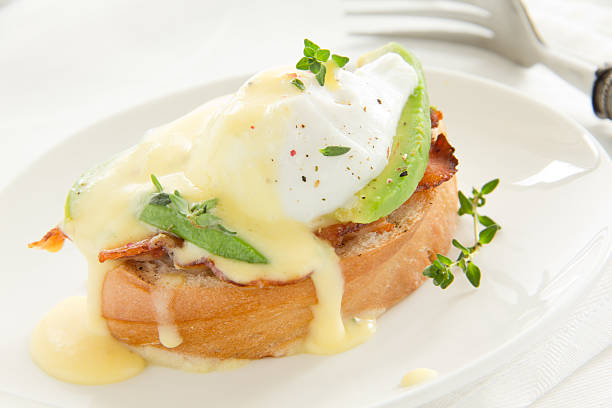 istock Breakfast. Poached egg with hollandaise sauce, bacon and avocado. 186199703