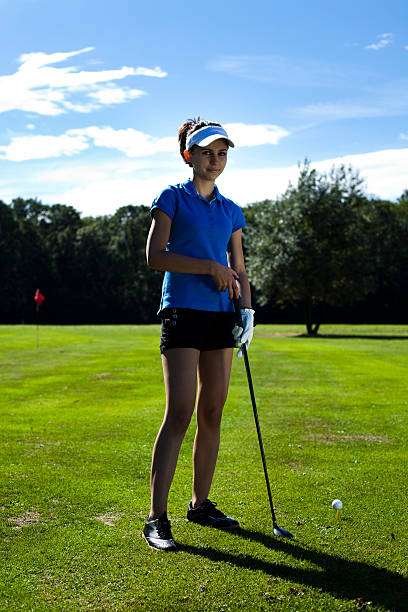 istock Woman playing golf on field 186200583
