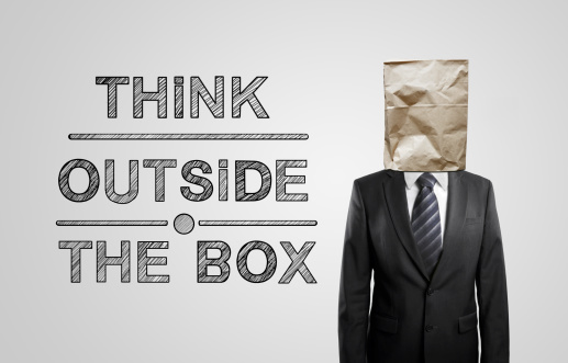 businessman with paper bag and drawing think outside the box