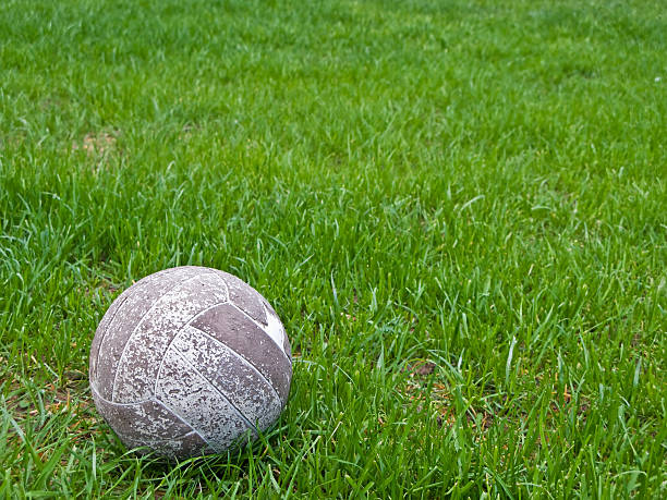 istock Old soccer ball in a green grass field 186201410
