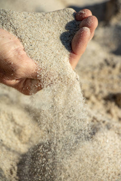 istock Man Hand Dropping a Handful of Sand 1862019718