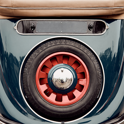 Back view of classic cabriolet car spare tire.