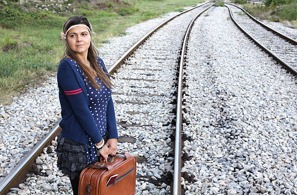 cross roads - leaving loneliness women railroad track stock-fotos und bilder