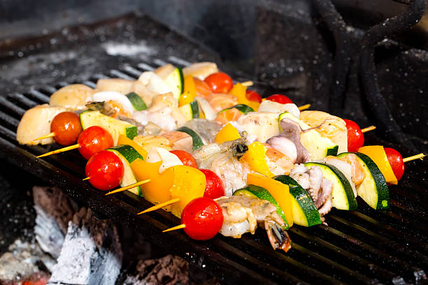 istock cooking kebabs from seafood and vegetables 186204056