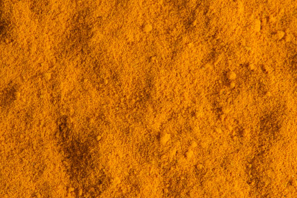 Turmeric spice background on macrophotography.