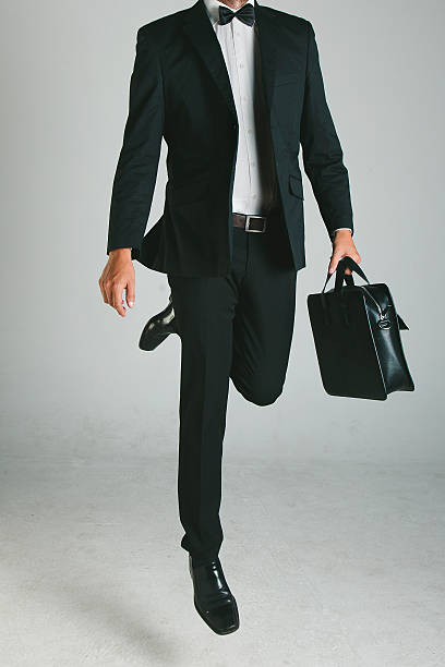 istock Stylish young man with black suit and briefcase. 186204822