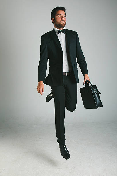 istock Stylish young man with black suit and briefcase. 186204844