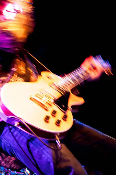 motion blur abstract of a rock guitarist with a golden guitar