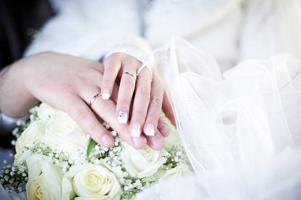 istock Hands and rings on wedding bouquet 186211726