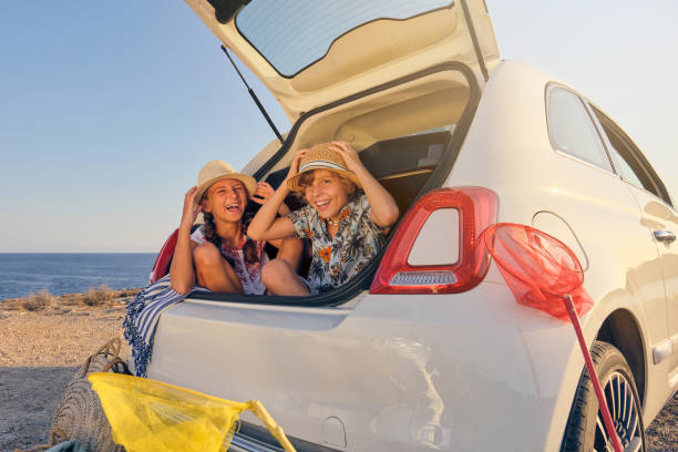 istock Kids inside the trunk of the car making jokes while touching the 1862119365