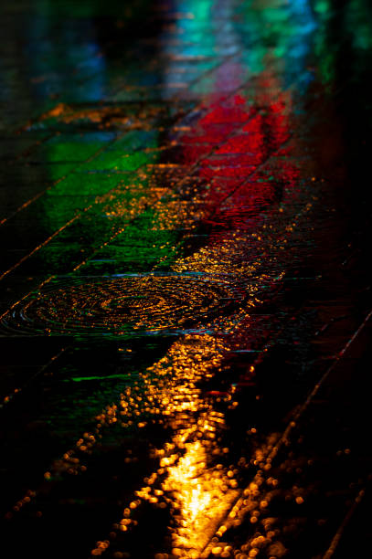 istock Abstract, wet pavement illuminated at night by colorful lights 1862121981
