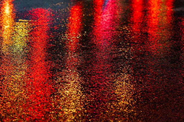 istock Abstract, wet asphalt road illuminated at night by colorful lights 1862121989