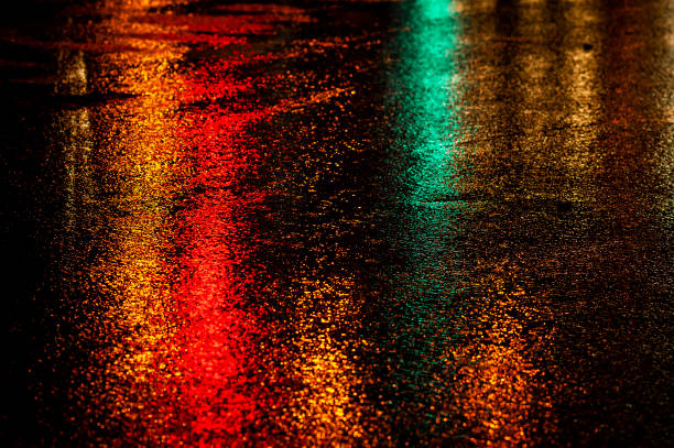 istock Abstract, wet asphalt road illuminated at night by colorful lights 1862121997