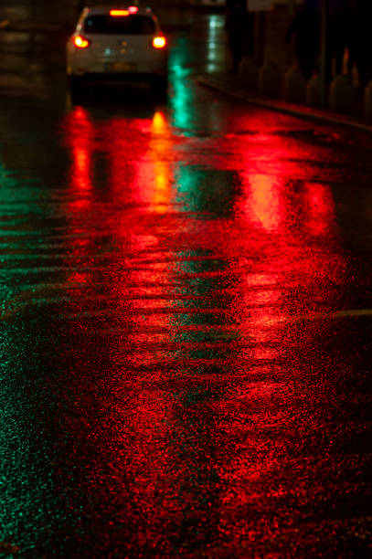 istock Abstract, wet asphalt road illuminated at night by colorful lights 1862122010