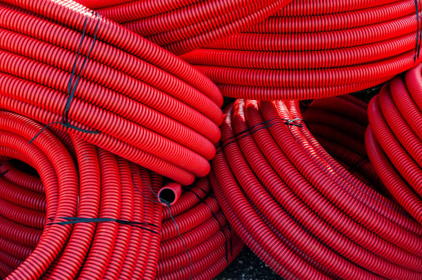istock Large coils of red, plastic, water irrigation hosing 1862122142