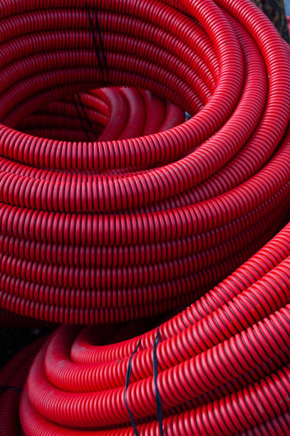 istock Large coils of red, plastic, water irrigation hosing 1862122147