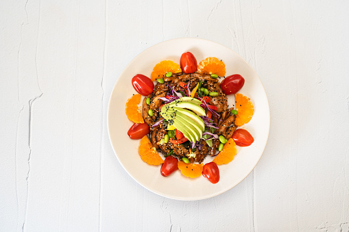 healthy chicken teriyaki and avocado salad on a plate