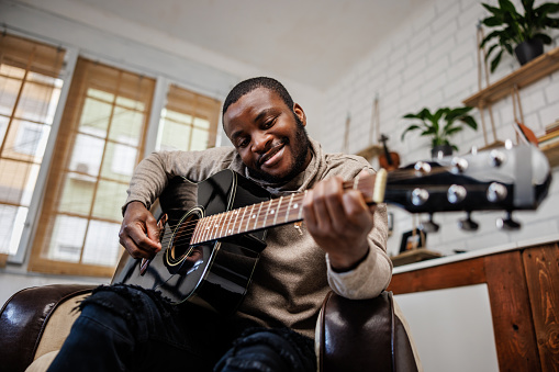 Professional guitarist composes music in home studio