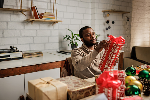 Man prepares Christmas gifts for loved ones