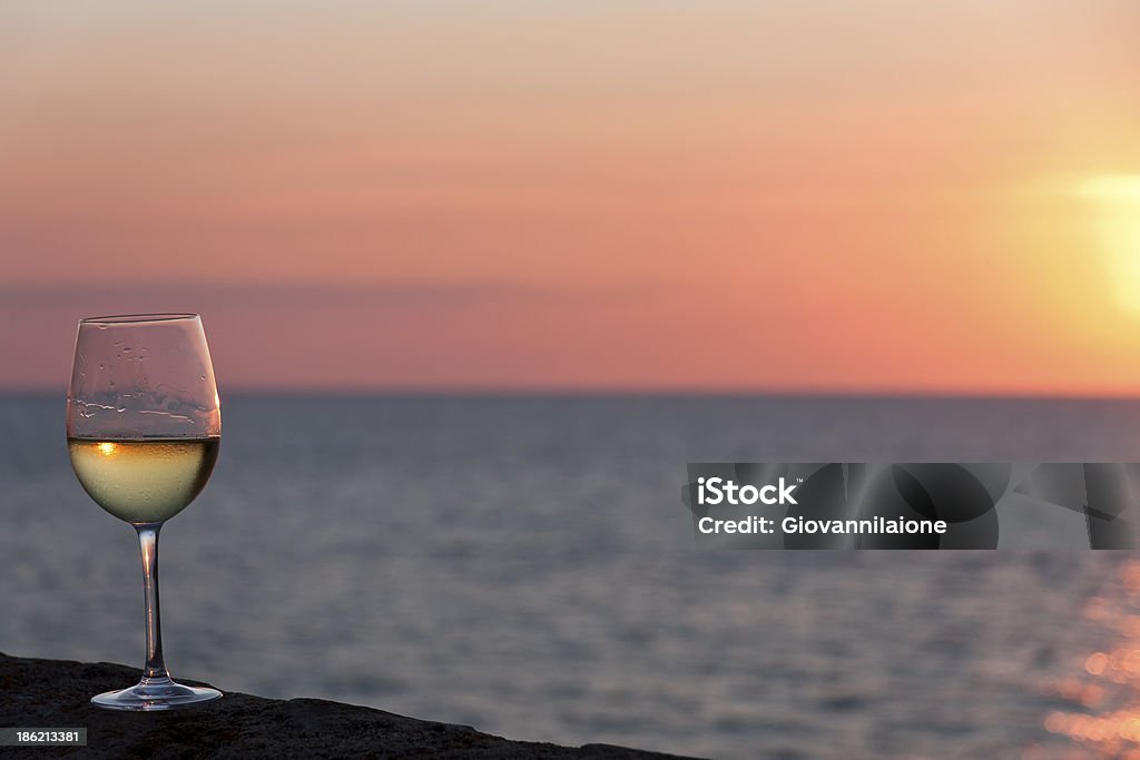 Sunset with wine Sunset on the sea and a glass of white wine After Work Stock Photo
