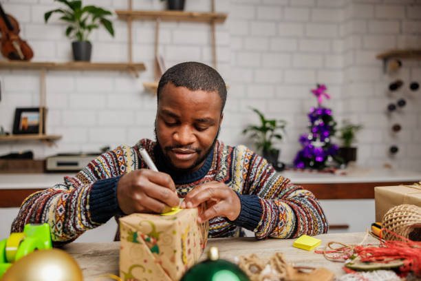 istock Young man writes a dedication on the Christmas greeting card 1862136596
