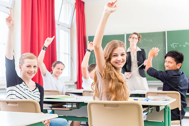 istock Teacher teaching a class of  pupils in school 186214240